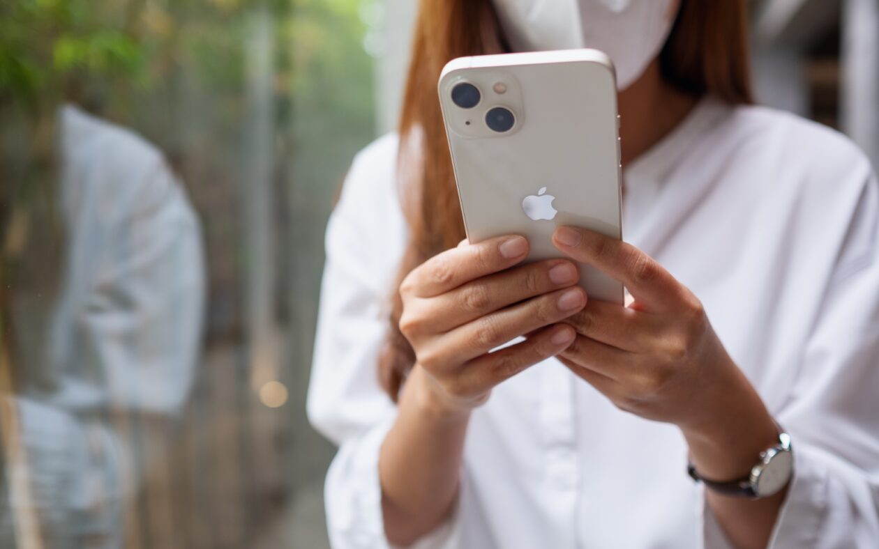 Mulher usando o iPhone 13 com máscara